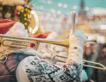 santa playing trombone in winterscape holiday scene