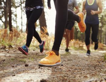 people running in woods in a race, view of feet