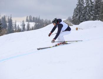 man skiing down mountain