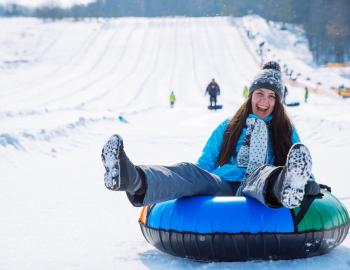 woman snow tubing 