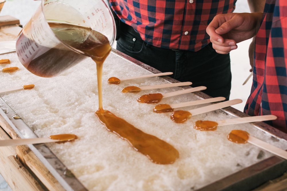maple syrup being poured onto snow