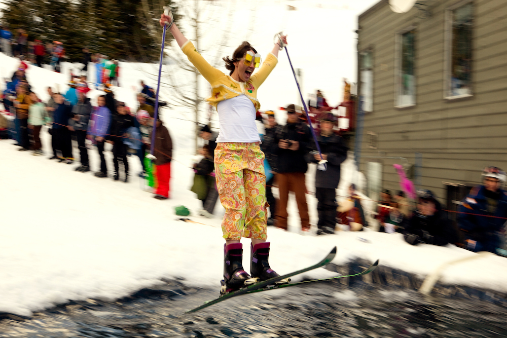 woman competing in a pond skim winter ski contest