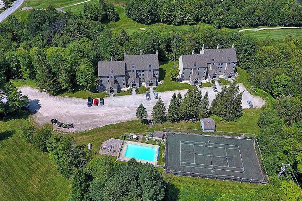 aerial view of wiffletree condo complex in killington, vt showing pool and tennis court